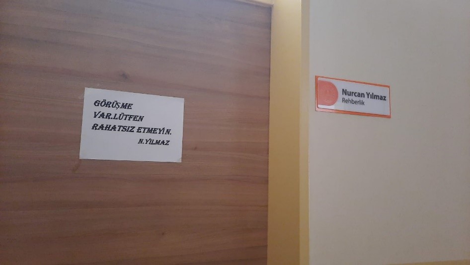 A sign on the door writing there is an interview going on, please do not disturb.